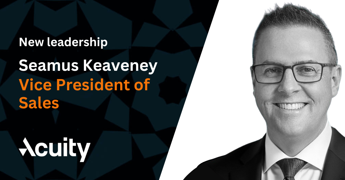 Black and white professional portrait of a businessman in glasses against a background diagonally split between a grey and black geometric pattern and a plain white section. White and orange text on the image describes the new VP of Sales at Acuity Trading.