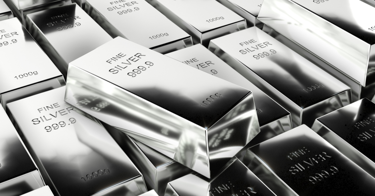 Shiny bars of silver stacked in rows. They are each embossed with the words 'Fine Silver 999.9'.
