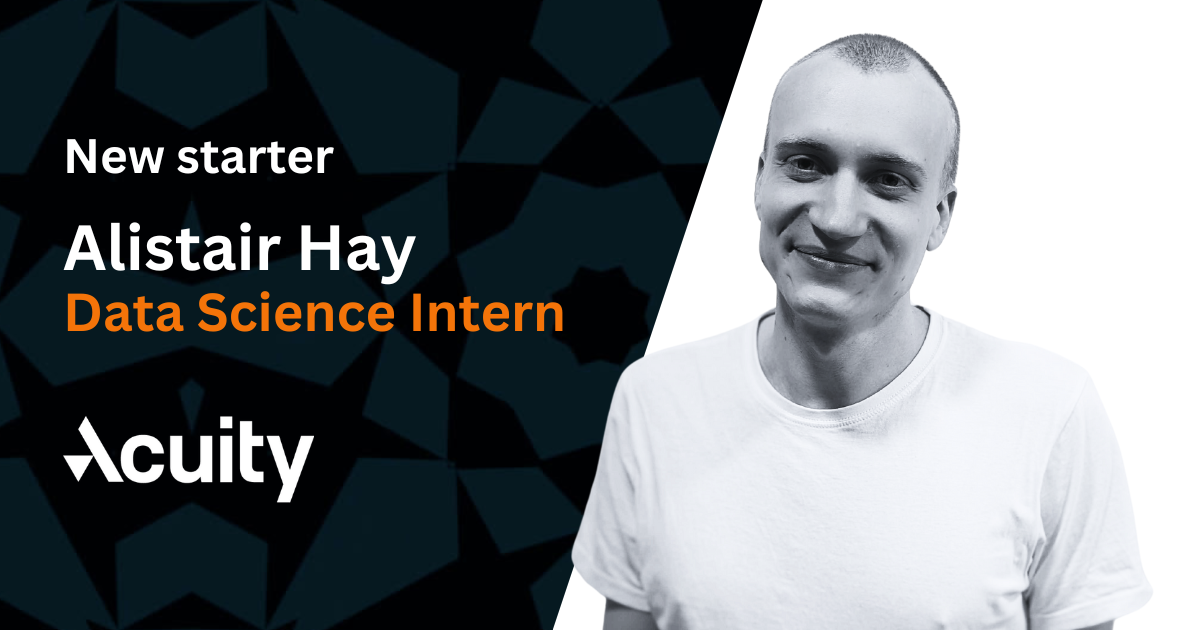A diagonally bisected landscape image with a grey and black geometric pattern on the left and plain white on the right, featuring a black and white image of a smiling man in a white t-shirt and text announcing his appointment to Acuity Trading on the left.